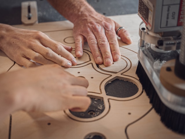 Focus on hands and wooden prototype of Timelab Gent on their Mekanika Pro