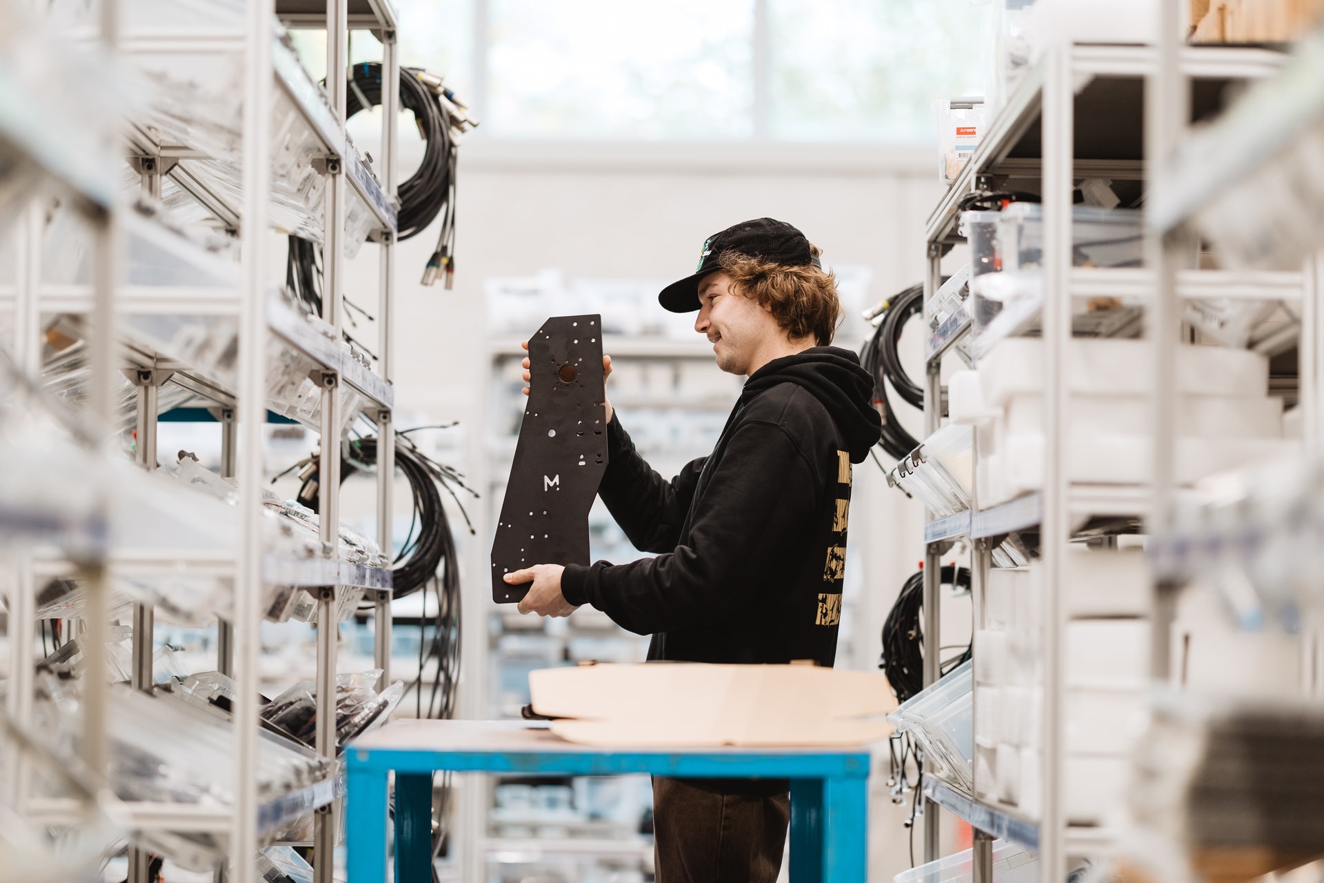 Mekanika employee in the workshop picking elements for the ongoing order