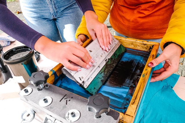 Focus on hands while printing blue t shirts